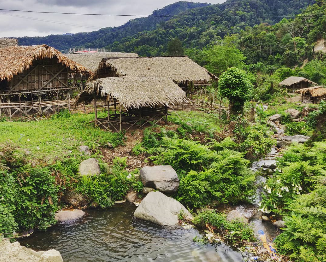 Indigenous houses dot the rural landscape