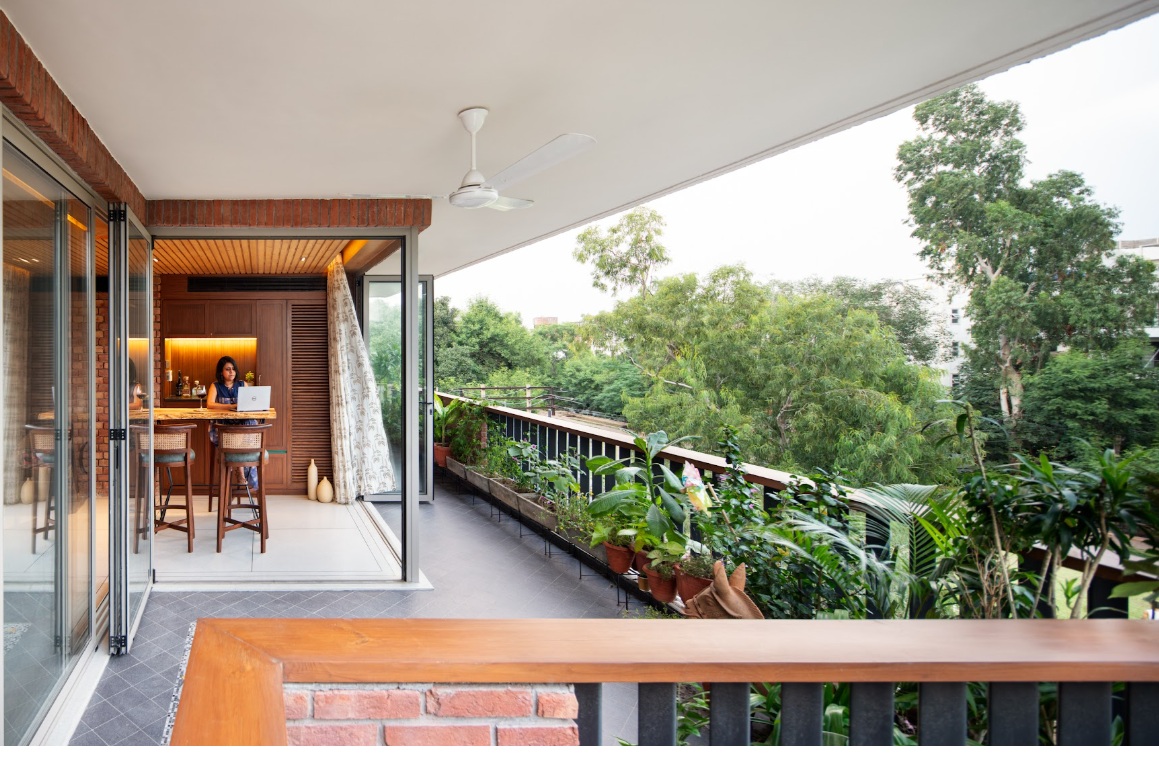 Designed around greenery and light, this balcony works equally well as a quiet corner to work, read, or unwind. _ Pic Credit - Noughts & Crosses